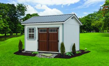 White Signature Oakdale Shed with light blue-green trim, brown double doors, and gray roofing.