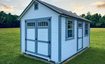 White Compass Garden Shed with gray-blue trim.